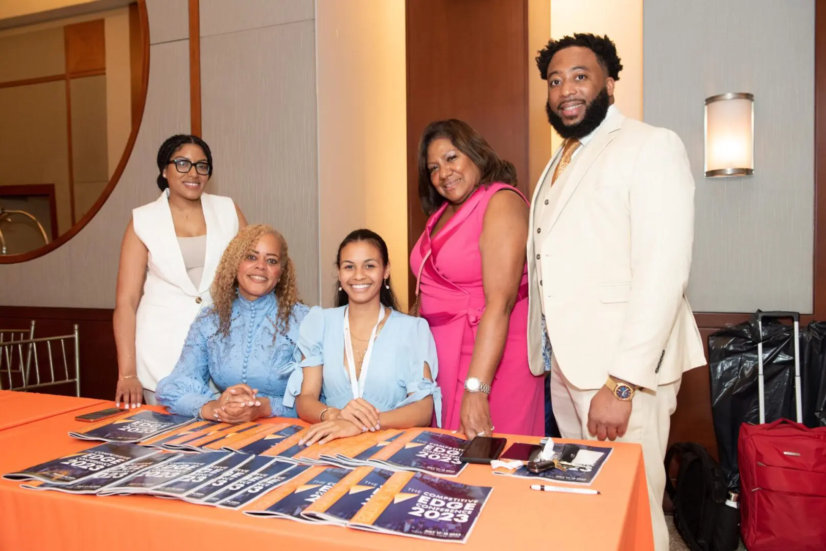 A group of people standing around a table.