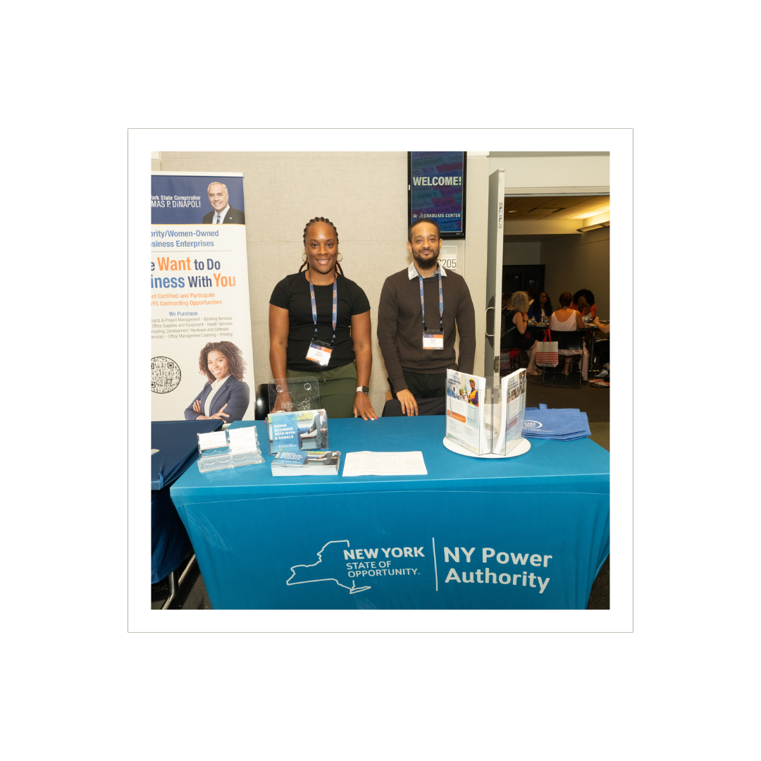 Two people standing at a NY Power Authority table.