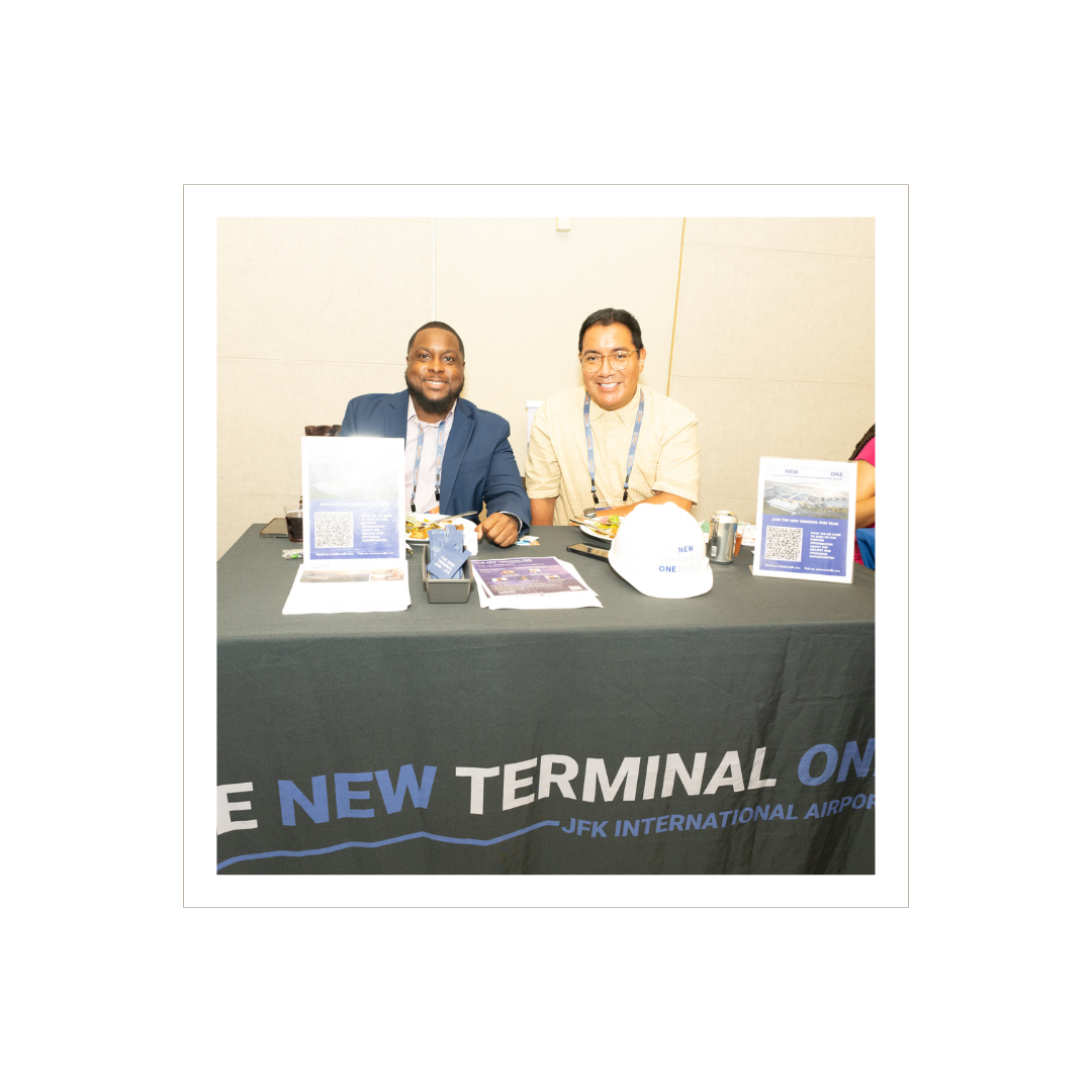 Two men at a table for JFK Airport's new terminal.